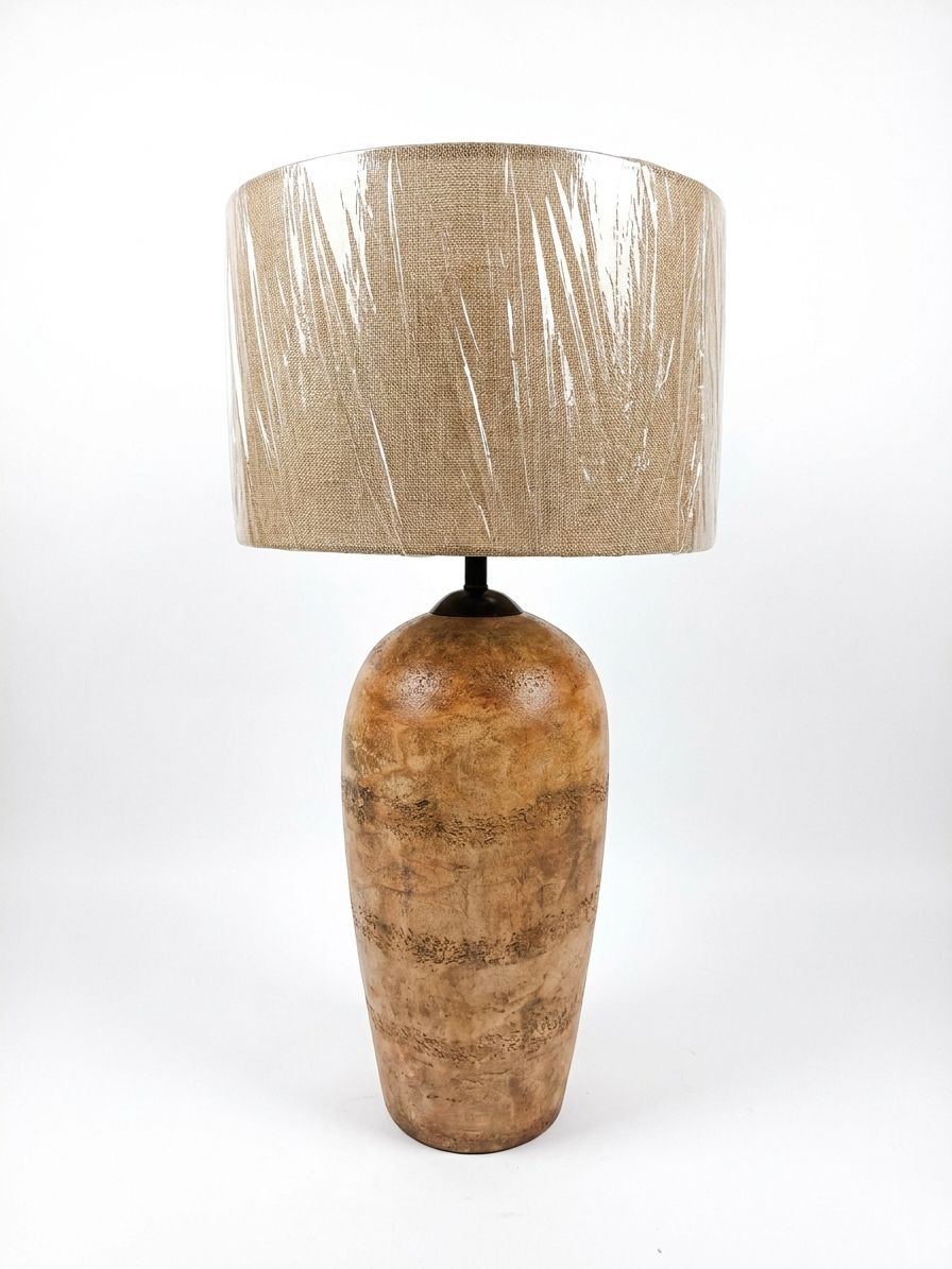 Fossil-Texture Urn Table Lamp, a ceramic and fabric table lamp, studio photograph on a white background