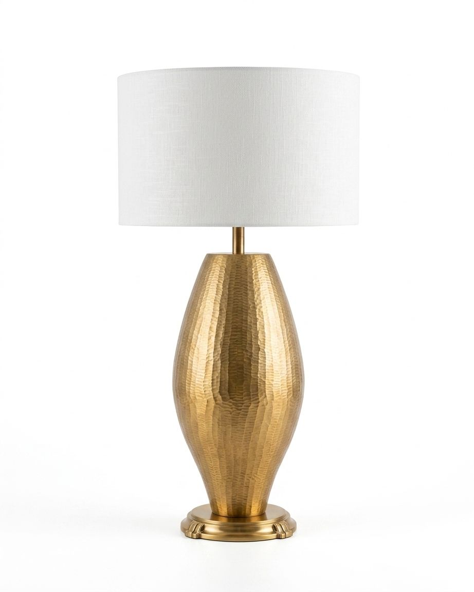 Hammered Brass Oval Table Lamp, a brass and fabric table lamp, studio photograph on a white background