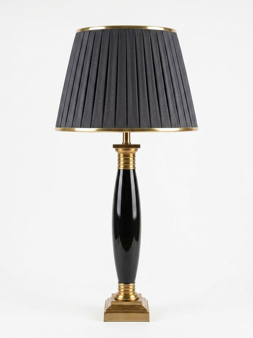 Black Ceramic Torpedo Table Lamp, a ceramic and brass and fabric table lamp, studio photograph on a white background