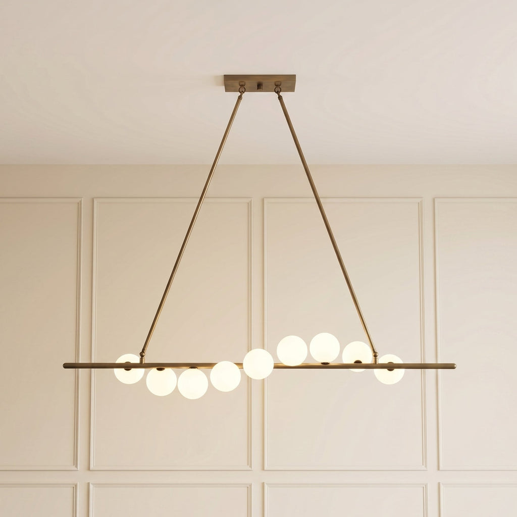 Vela Brass Globe Chandelier illuminated