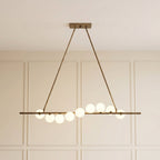 Vela Brass Globe Chandelier illuminated