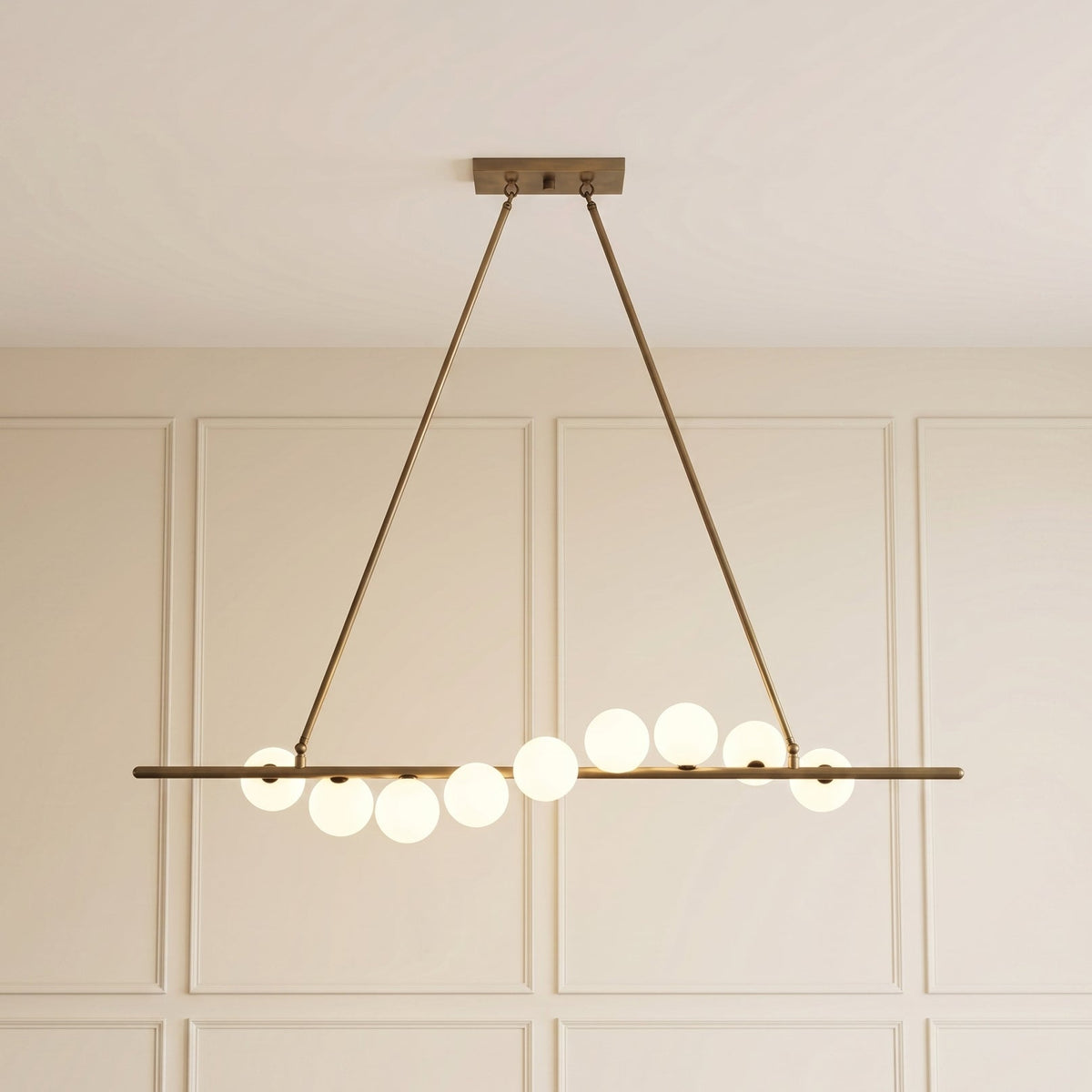 Vela Brass Globe Chandelier illuminated