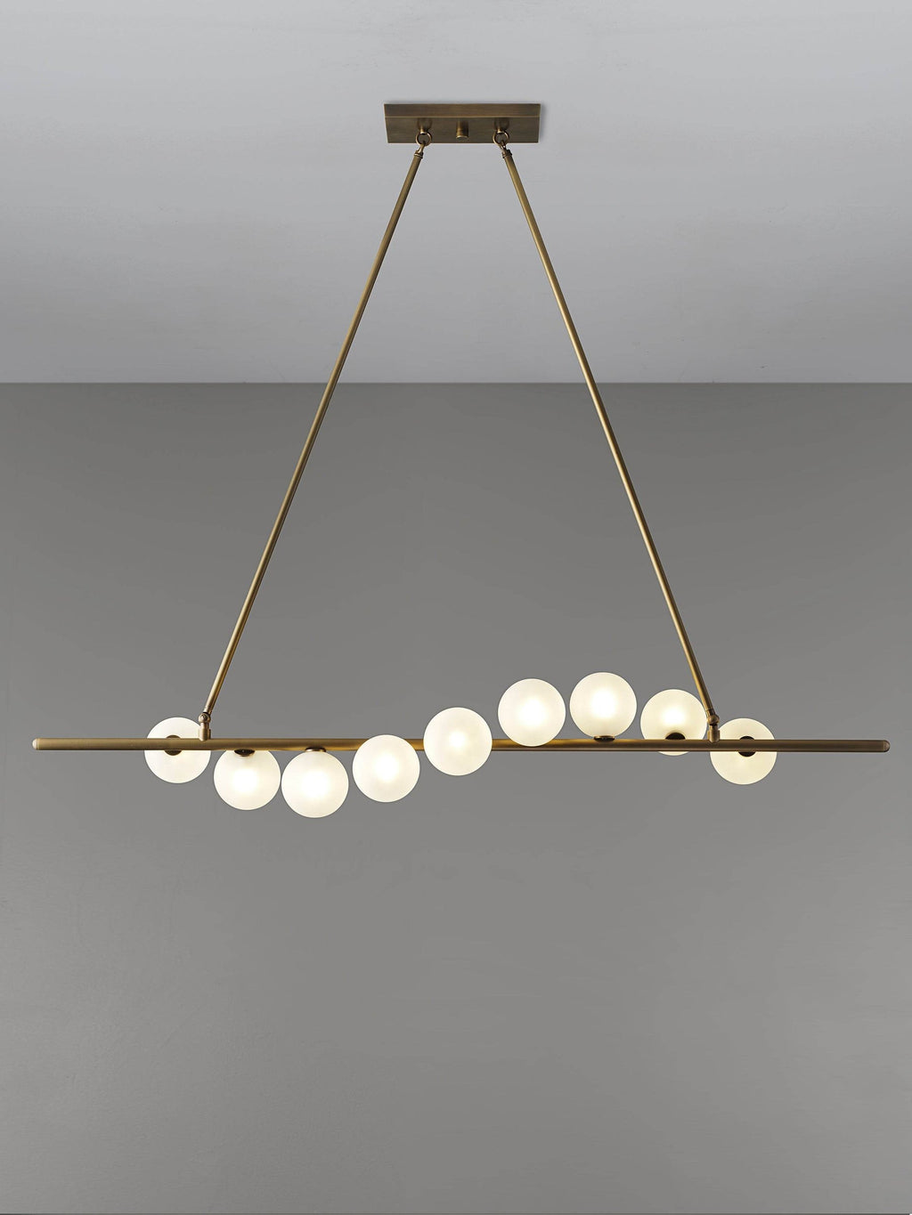 Vela Brass Globe Chandelier dining setting