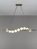 Vela Brass Globe Chandelier dining setting