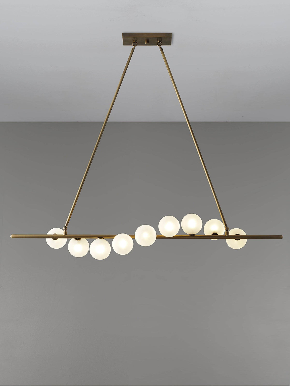 Vela Brass Globe Chandelier dining setting