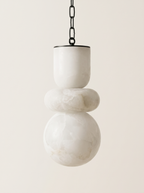 Alabaster Stack Pendant Light, three hand-turned natural alabaster forms on a black chain, front view