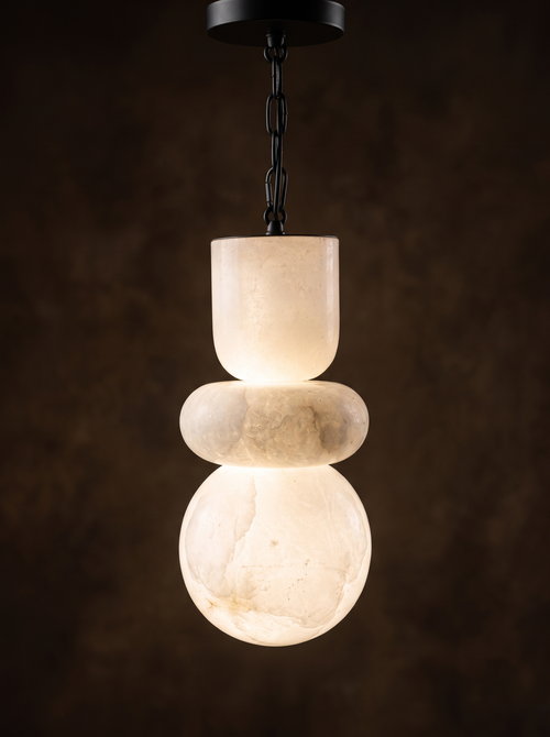 Alabaster Stack Pendant Light switched on, the veined alabaster glowing warm white from within