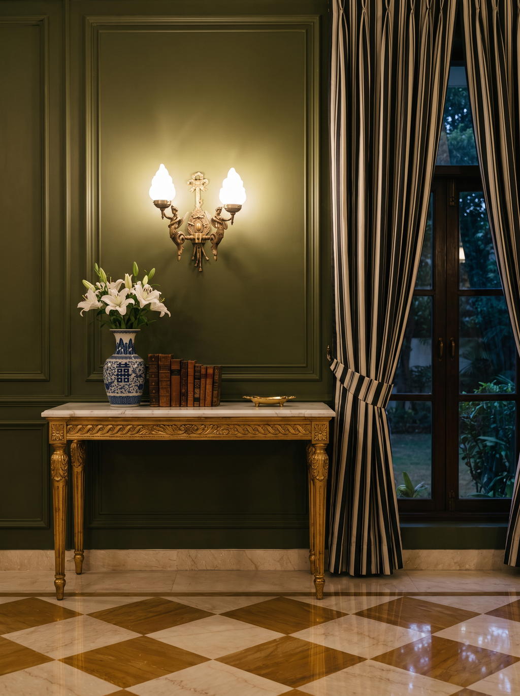 Apsara Double Wall Light glowing above a marble-topped console on a panelled wall in a classical salon at dusk