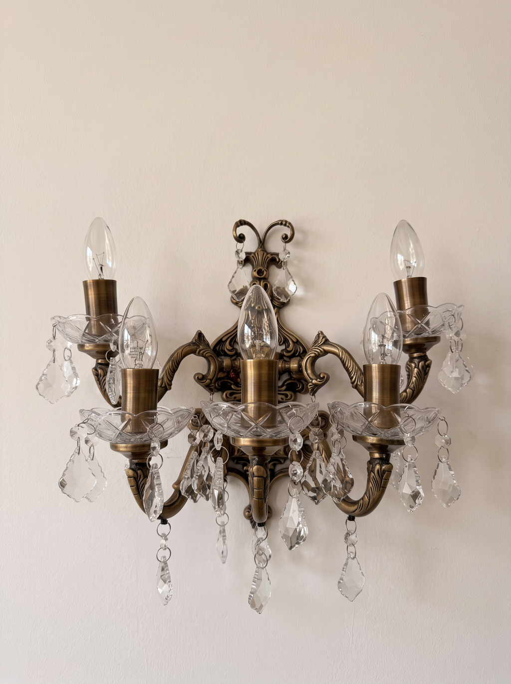 Bohemia Five-Light Brass and Crystal Wall Light, antique brass arms with scalloped cut-glass bowls and crystal drops, front view