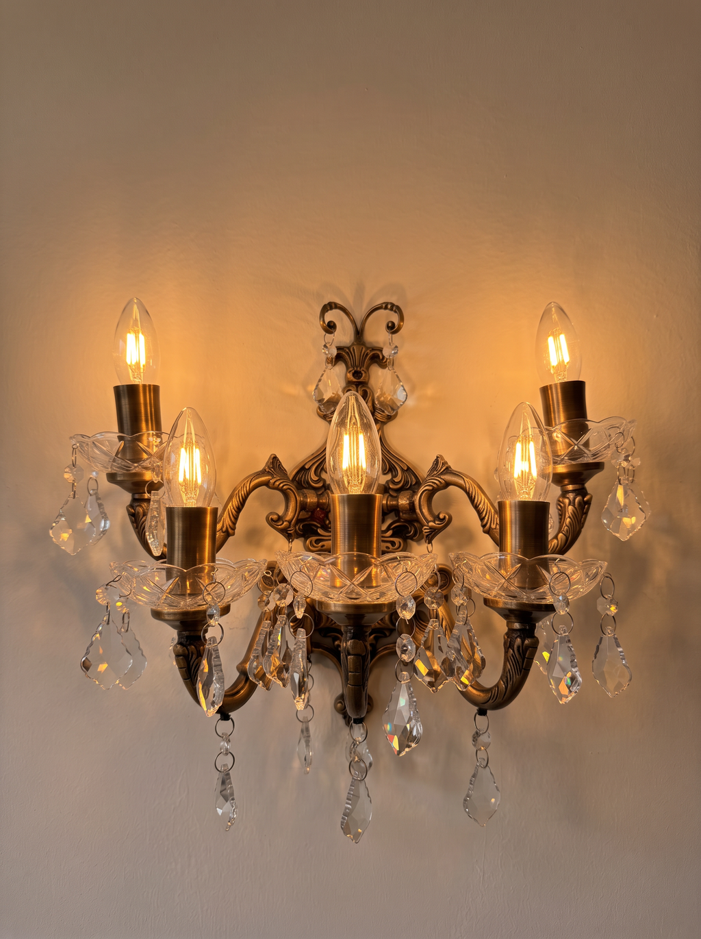 Bohemia Wall Light with all five candles lit, the cut glass and crystal sparkling
