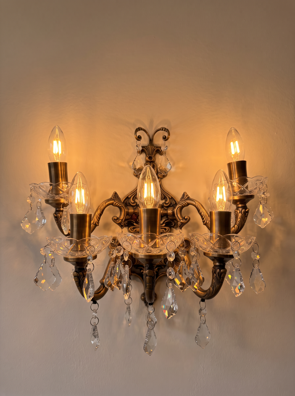 Bohemia Wall Light with all five candles lit, the cut glass and crystal sparkling