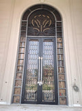 Classical arched farmhouse main door with botanical metalwork