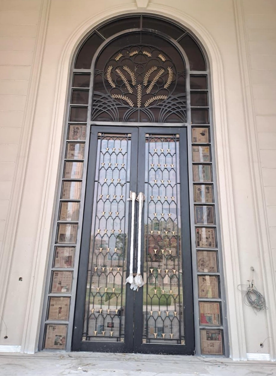 Classical arched farmhouse main door with botanical metalwork