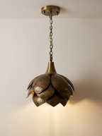 Brass Petals Pendant, Small, switched on, with warm light falling from the base