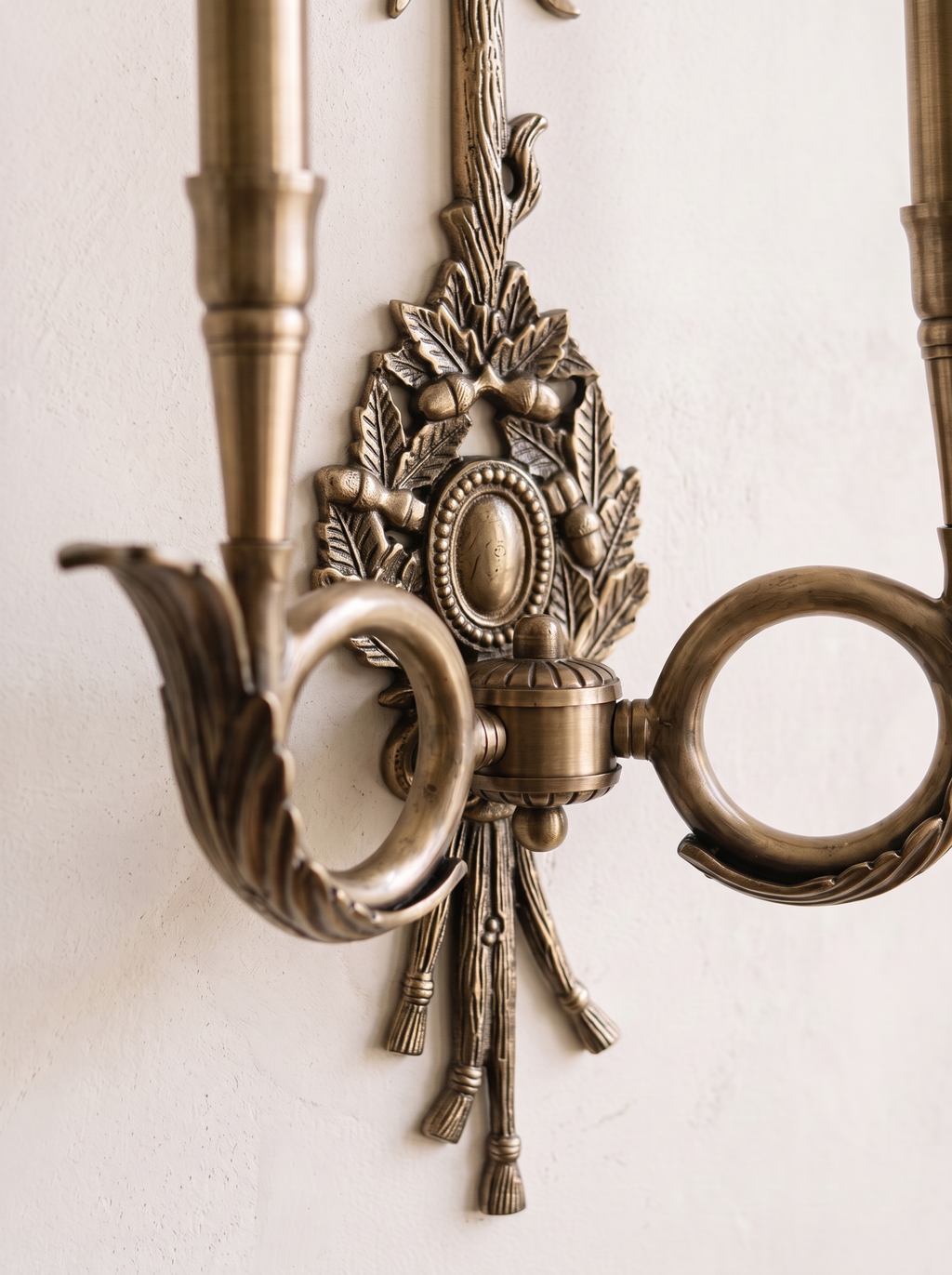 Close-up of the cast brass oak-leaf trophy, oval medallion, tassels and a coiled hunting-horn arm