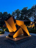 Angular corten steel sculpture at dusk