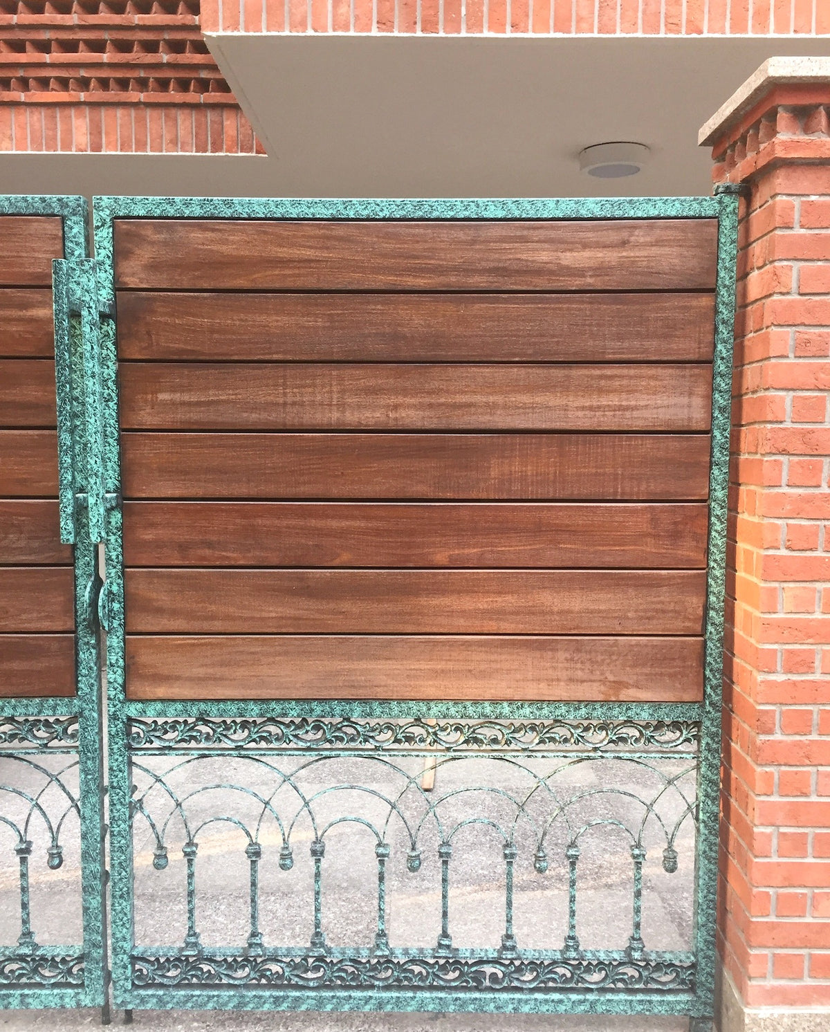 Detail of wood and green patina cast metal gate