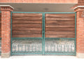 Wood gate with green patina cast metal arches and borders