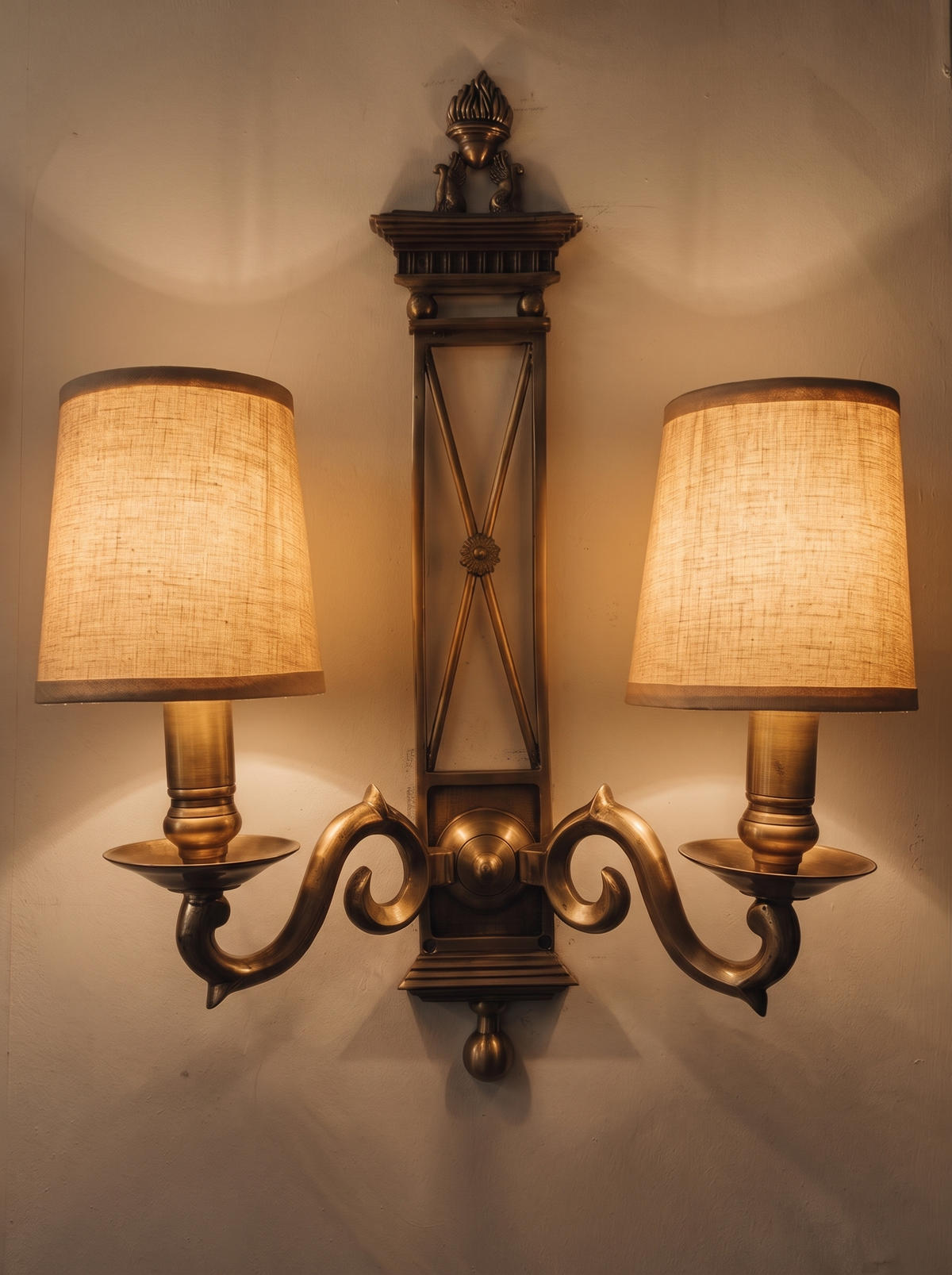 Directoire Double Wall Light switched on, both linen shades glowing warm on the wall