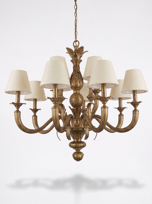 Acanthus Crown Brass Chandelier, antique brass acanthus and pinecone column with nine reeded arms and ivory linen shades, front view