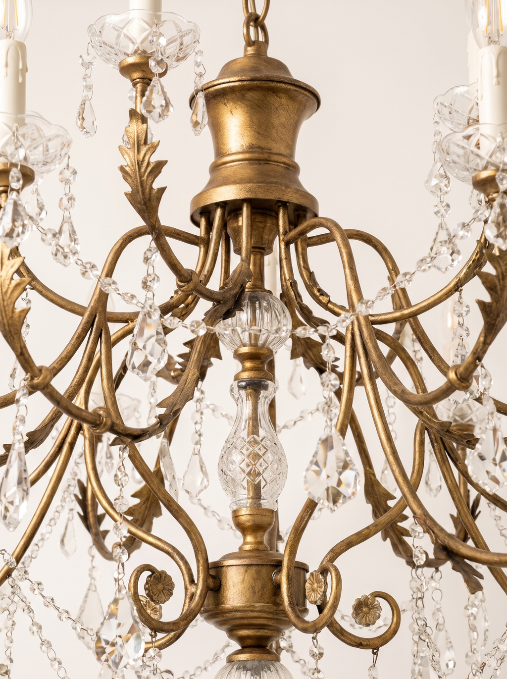 Close-up of the antique gold urn, cut-glass column, leafy scroll arms and crystal swags
