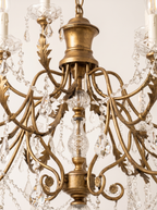 Close-up of the antique gold urn, cut-glass column, leafy scroll arms and crystal swags