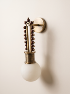 Mala Wall Light three-quarter view, showing the backplate, arm and 7-inch projection