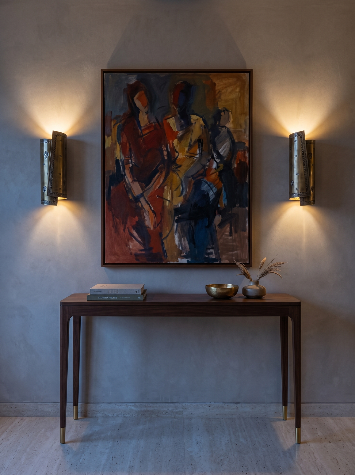 Pair of Patra brass scroll sconces lit on either side of an abstract painting above a walnut console