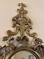 Close-up of the cast brass crest of C-scrolls, acanthus leaves and fleur-de-lis above the mirror