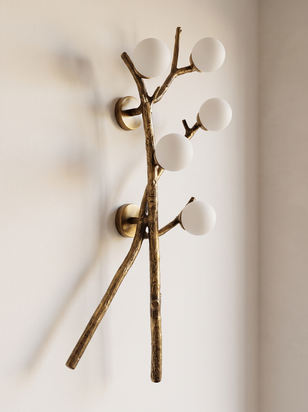 Shakha Branch Wall Light three-quarter view, showing the brass branches standing off the wall on two round plates