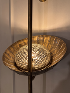 Close-up of the large hand-etched brass bowl, its dotted inner dome sparkling with light