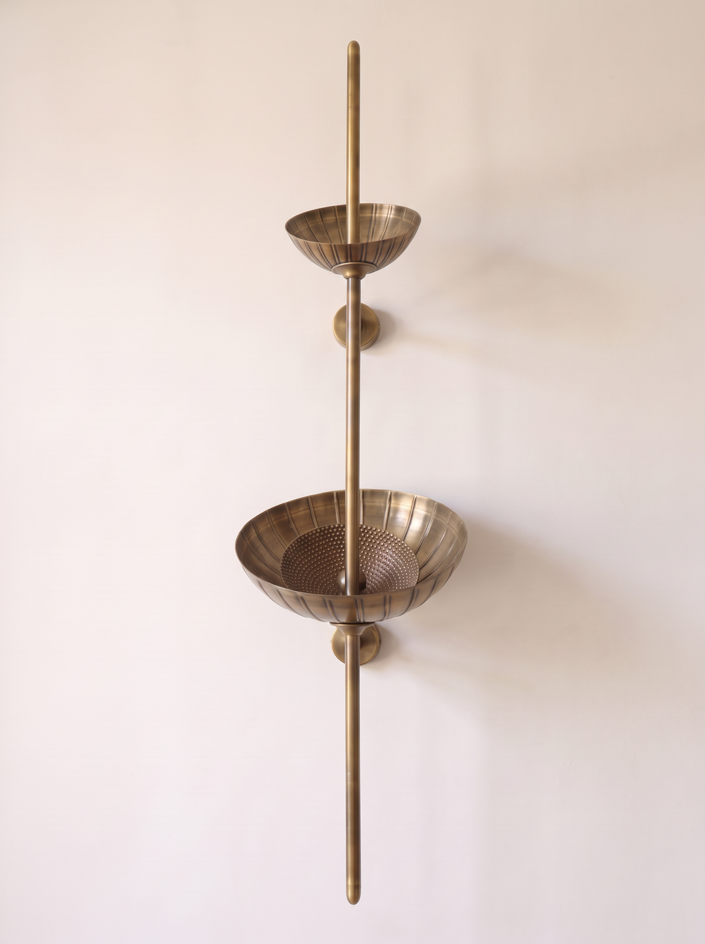Stambha Etched Brass Wall Light, a slender brass stem with two hand-etched bowls, front view