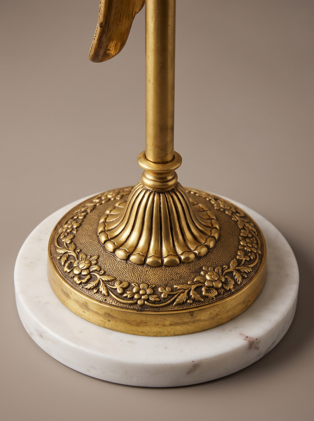 Close-up of the cast brass flowered foot and white marble base of the Brass Parrot Table Lamp