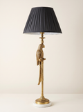 Brass Parrot Table Lamp with a cast brass parrot on a slim column, white marble base and pleated charcoal shade, front view