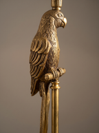 Close-up of the cast brass parrot on the Brass Parrot Table Lamp, gripping its brass perch