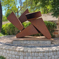 Intersecting broad plane metal sculpture at Westend Greens, front view