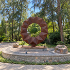 Faceted ring sculpture on circular stone base at Westend Greens
